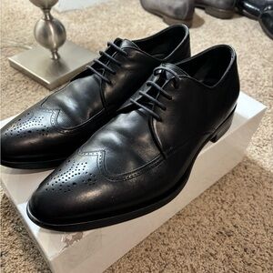 Giorgio Armani black leather wingtips.